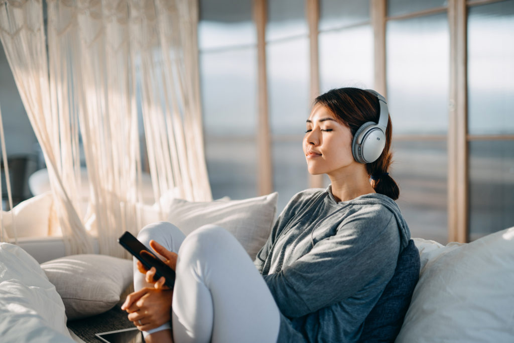 Woman unwinding with some music.