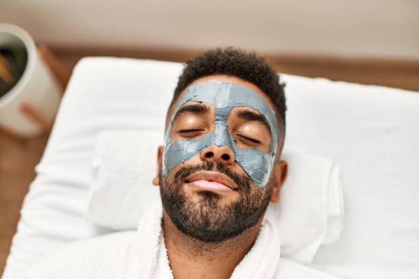 Man relaxing with a mud mask on