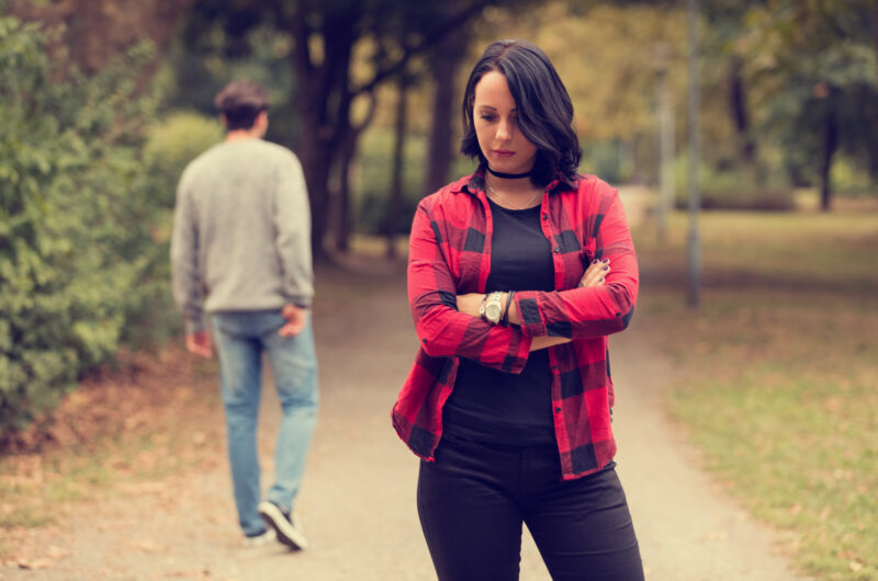 Man walking away from woman after a break up.