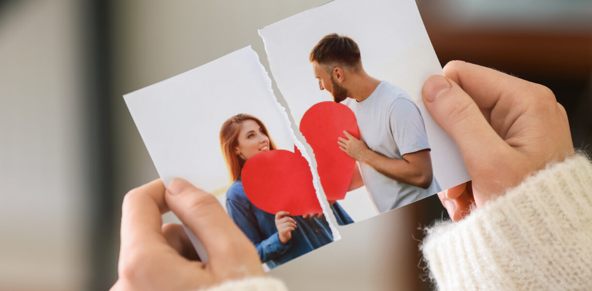 Woman tearing up photo of happy couple
