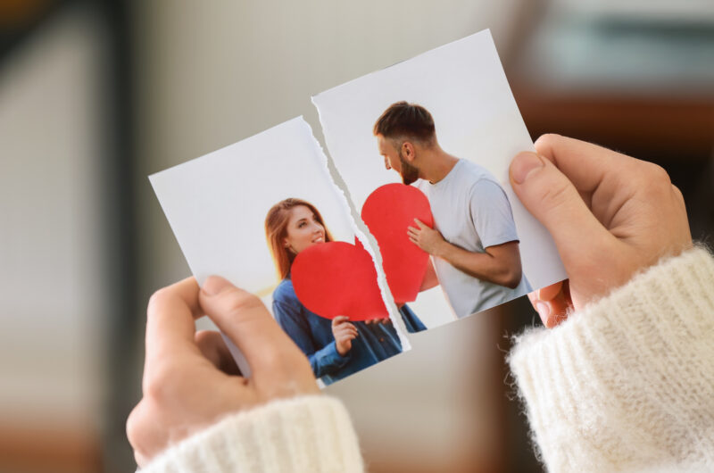 Woman tearing up photo of happy couple