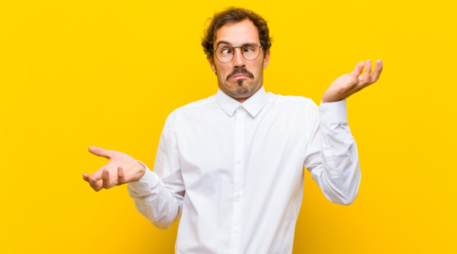 man shrugging with overly dramatic expression against a yellow background