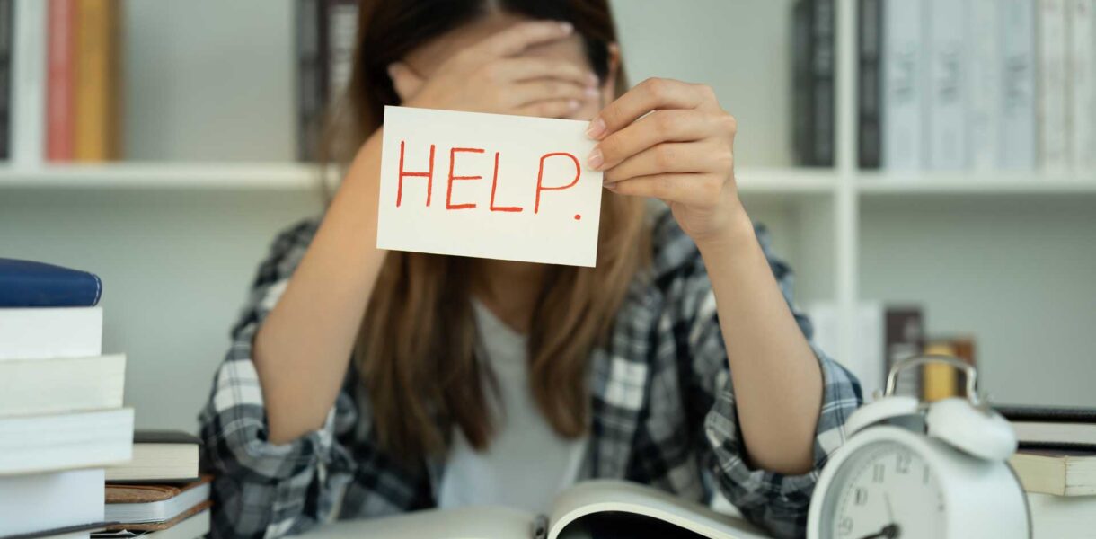 Asian student woman have anxiety because of exams, female hold help in the library. stress, despair, haste, misunderstanding reading, discouraged, expectation, knowledge