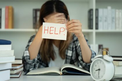 Asian student woman have anxiety because of exams, female hold help in the library. stress, despair, haste, misunderstanding reading, discouraged, expectation, knowledge