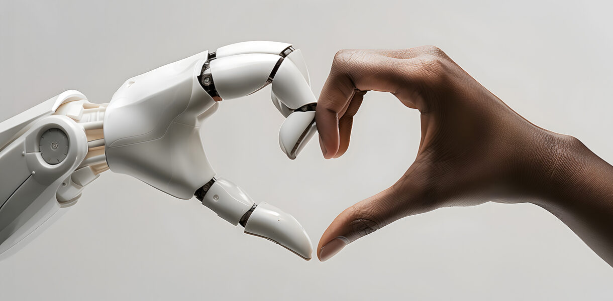 A white ai robot hand and a black human hand come together to form the shape of a heart. Heart shaped by human and ai robot hands. Isolated on light grey background.