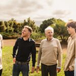 Happy multigenerational group of men with different ethnicities having fun in a public park
