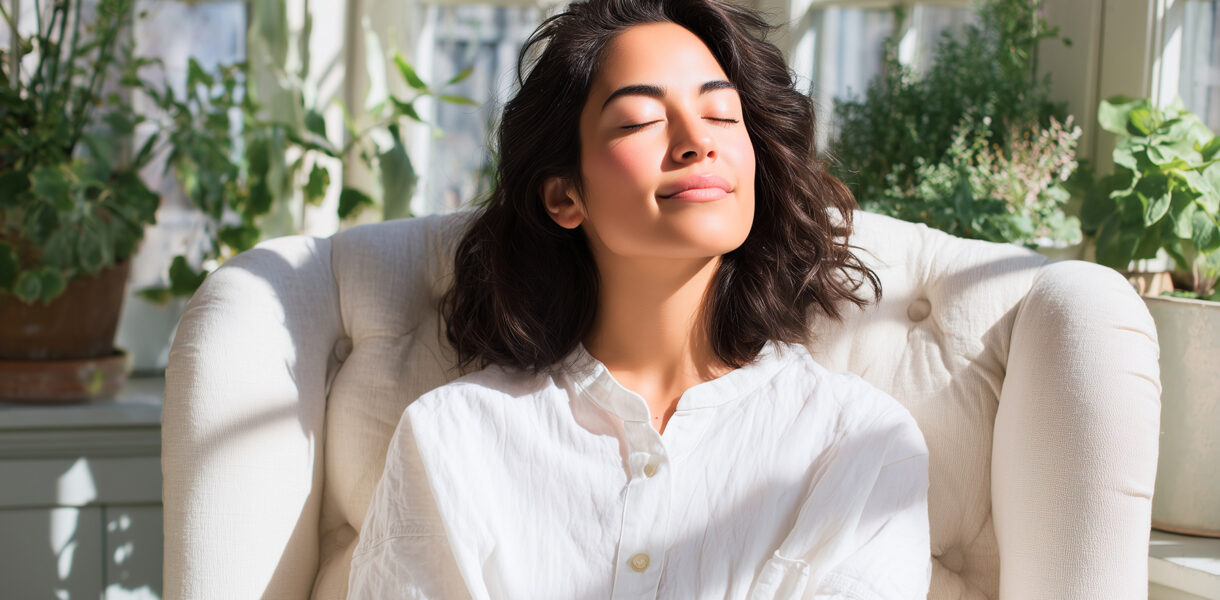 Relaxed woman enjoying sunlight indoors