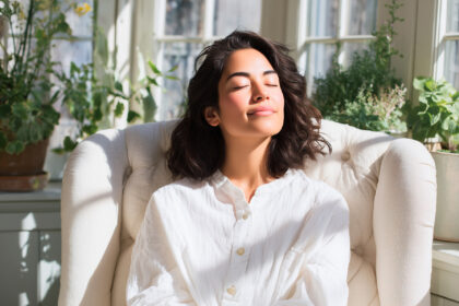 Relaxed woman enjoying sunlight indoors